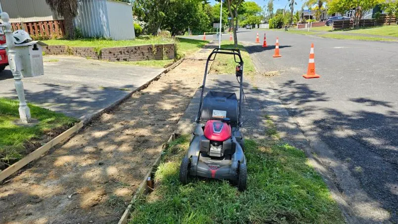 Street berm and section edge being mowed and tidied on the North Shore, Auckland